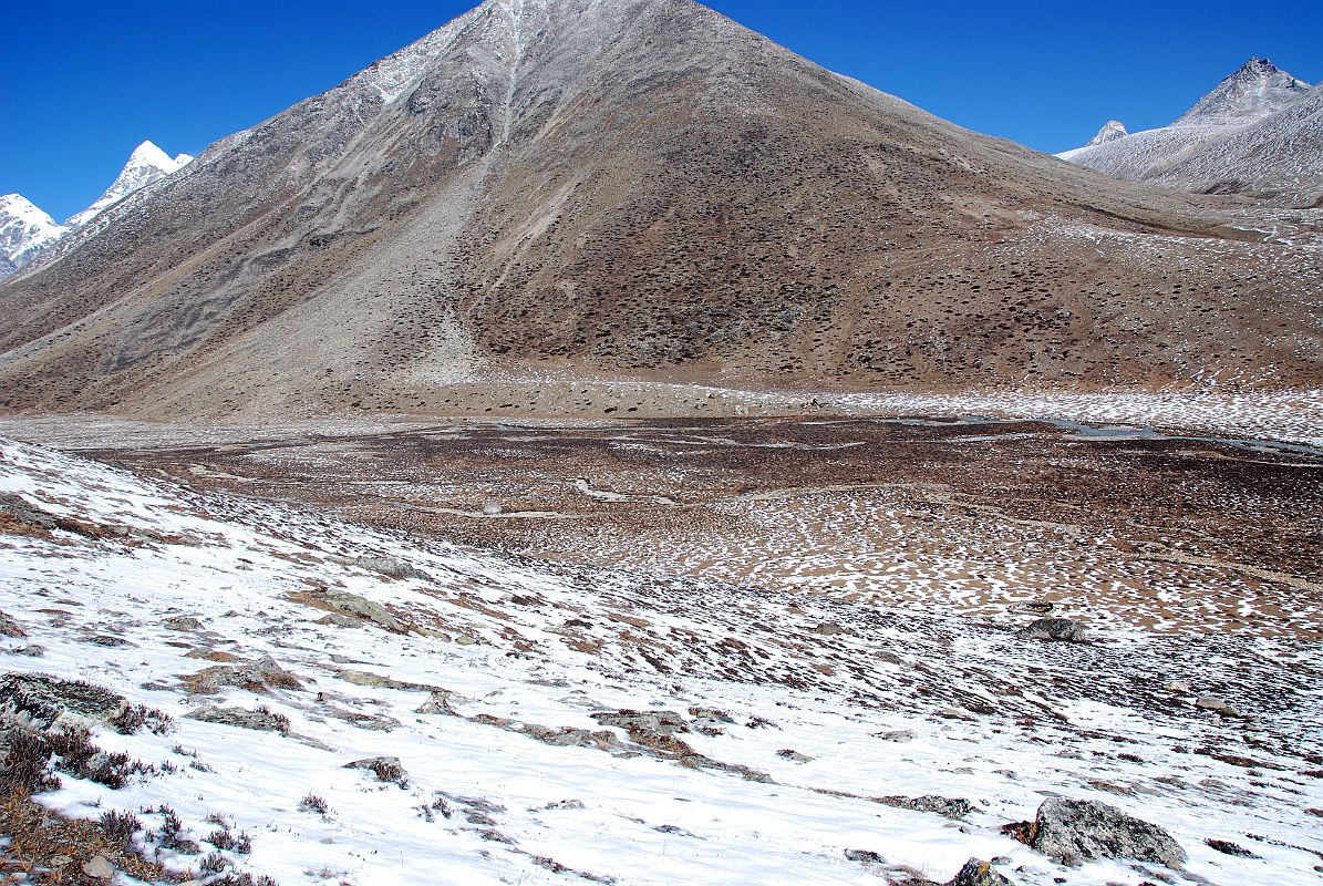 31 Shingdip Campsite On Trek To Shishapangma Advanced Base Camp Shingdip (4612m) is a meadow camp near the junctions of converging morainal valleys. Poking out on the left are Ice Tooth, Nyanang Ri and Shishapangma.